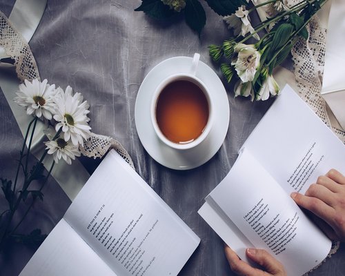 Book and tea on a cozy table representing relaxation