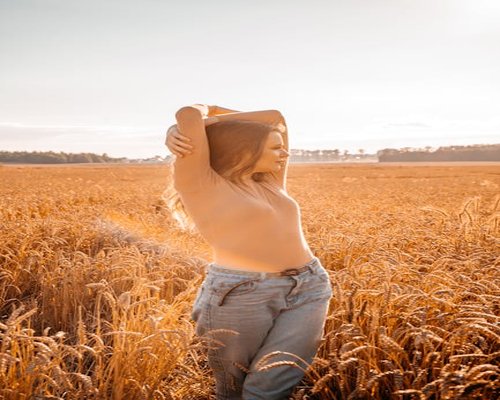 Calm woman stretching arms in a field